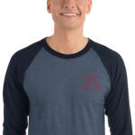 Model wearing a denim blue and navy blue 3/4 sleeve raglan shirt with the zSecurity logo on the chest, perfect for a relaxed and professional look.